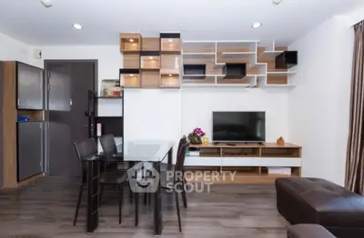 Modern living room with stylish shelving and dining area, perfect for urban living.