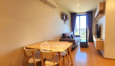 Modern living room with stylish decor and large window offering city views