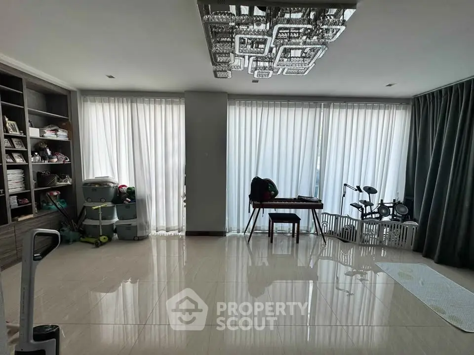Spacious living room with modern decor and large windows for natural light