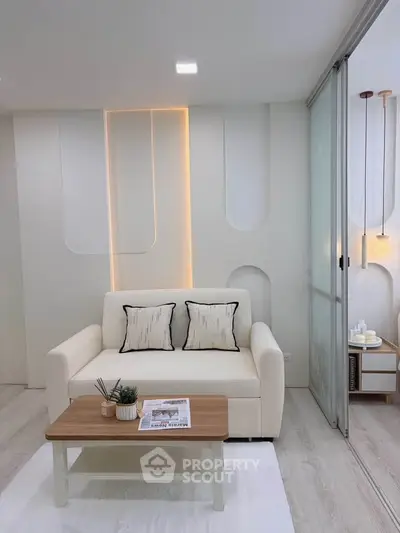 Modern living room with stylish decor and cozy ambiance, featuring a white sofa and elegant lighting.