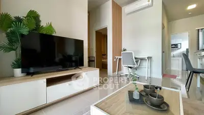 Modern living room with TV, air conditioning, and stylish decor in a cozy apartment.