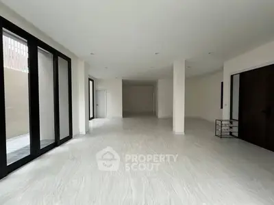 Spacious modern living room with large windows and sleek flooring
