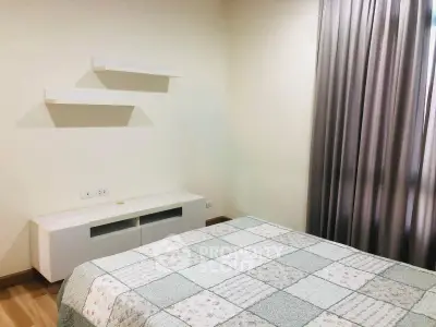 Cozy bedroom with modern decor and natural light, featuring a stylish bed and elegant curtains.