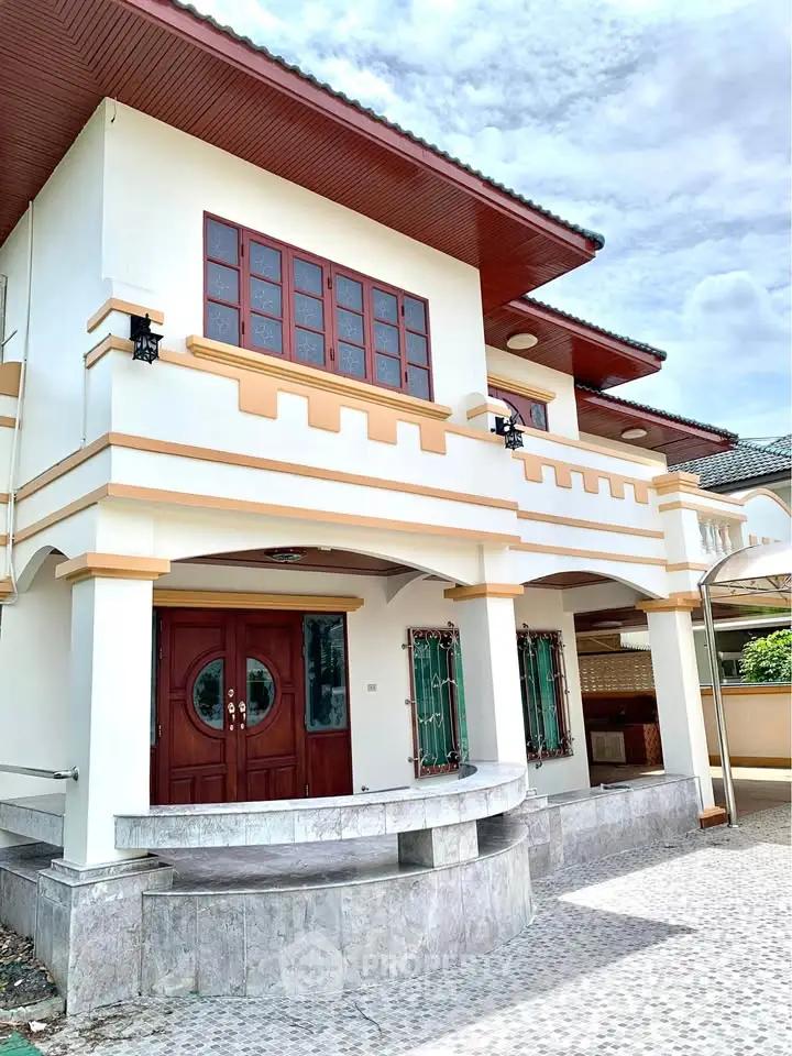 Elegant two-story house with unique architectural design and spacious entrance