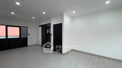 Spacious modern living room with sleek design and ample natural light.