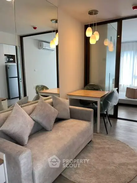 Modern living room with cozy gray sofa and stylish pendant lights