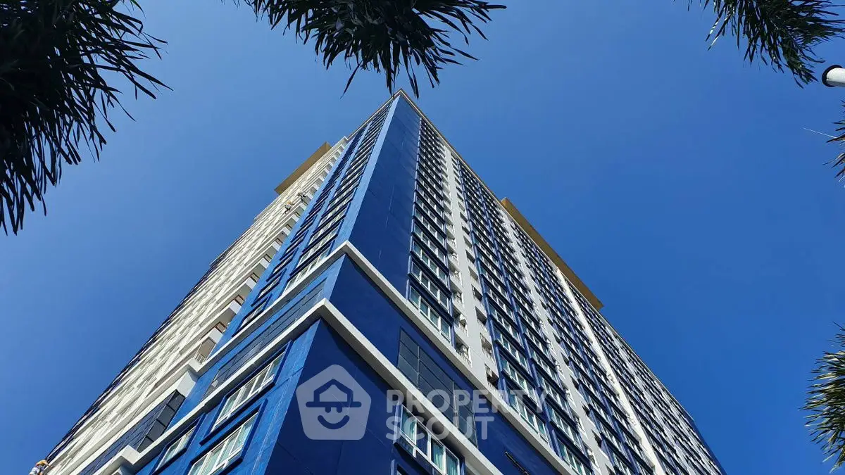Stunning modern high-rise building with blue facade against clear sky
