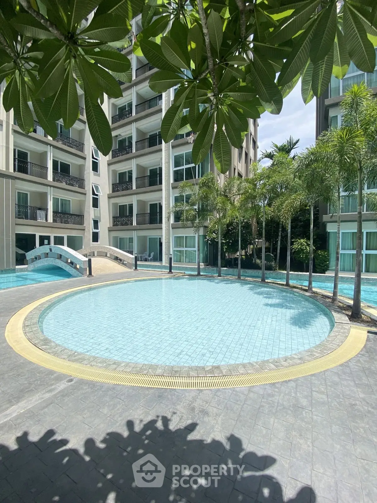 Luxurious condominium with stunning pool and lush greenery