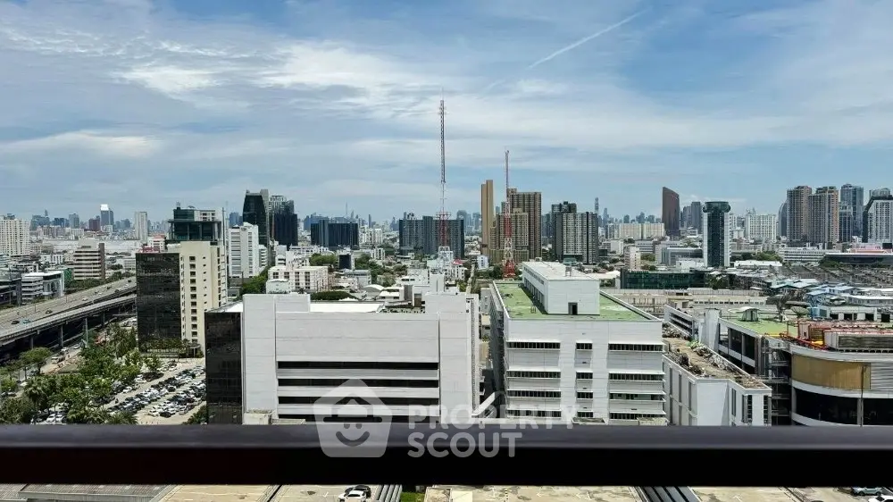 Stunning cityscape view from a high-rise balcony overlooking urban skyline.