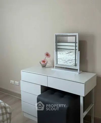 Modern bedroom with sleek white dresser and mirror, featuring elegant decor and soft lighting.