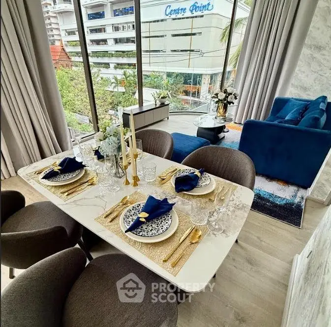 Luxurious dining and living area with elegant decor and city view