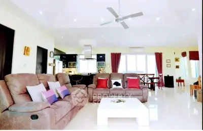 Spacious living room with modern decor and open layout, perfect for family gatherings.