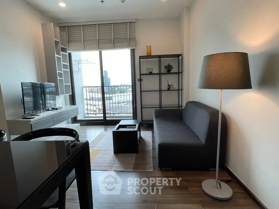 Modern living room with sleek furniture and city view balcony