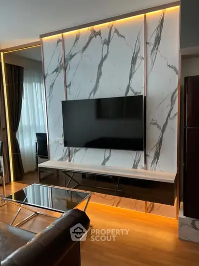 Modern living room with marble accent wall and sleek TV setup