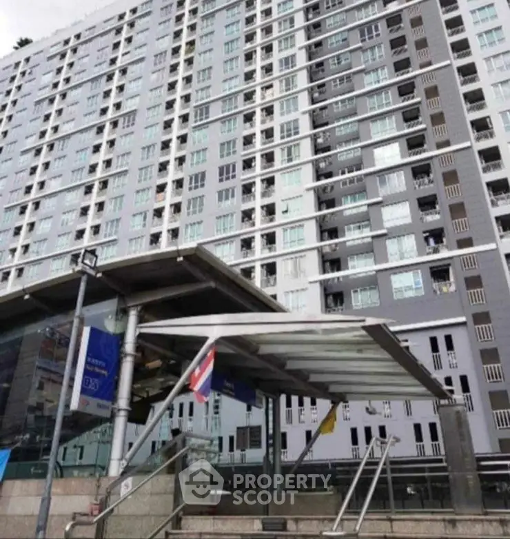 Modern high-rise building with sleek entrance and urban appeal