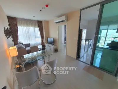 Modern living room with glass dining table and balcony view in stylish apartment