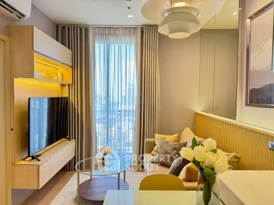 Modern living room with stylish decor and large window offering natural light.