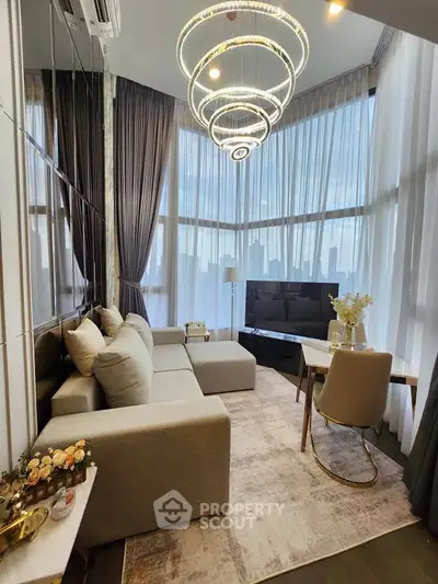 Luxurious modern living room with floor-to-ceiling windows and elegant lighting fixtures.