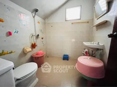 Charming bathroom with playful decor and natural light