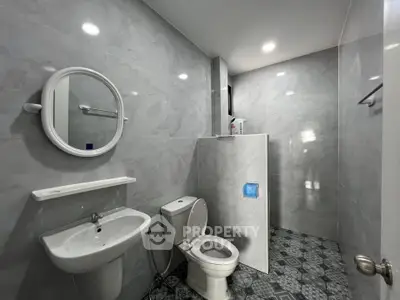 Modern bathroom with sleek gray tiles and contemporary fixtures.