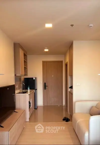 Modern apartment interior with compact kitchen and cozy living area