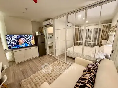 Modern studio apartment with glass partition, cozy living area, and stylish decor.