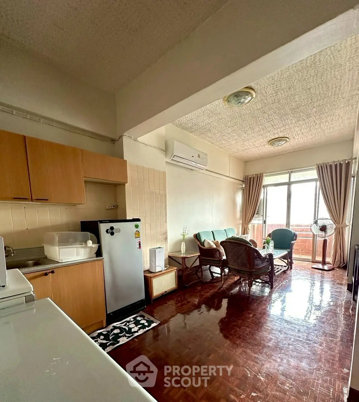 Charming living room with natural light, cozy seating, and modern appliances in an inviting open layout.