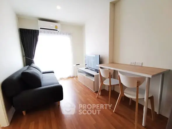 Modern living room with sleek furniture and natural light, perfect for cozy gatherings.