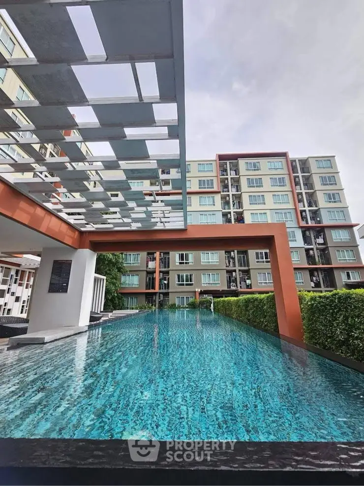 Modern apartment complex with stunning pool and contemporary architecture.
