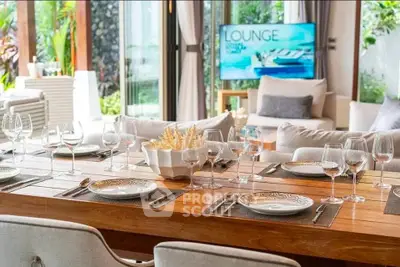 Luxurious dining area with elegant table setting and cozy living room view, perfect for entertaining.