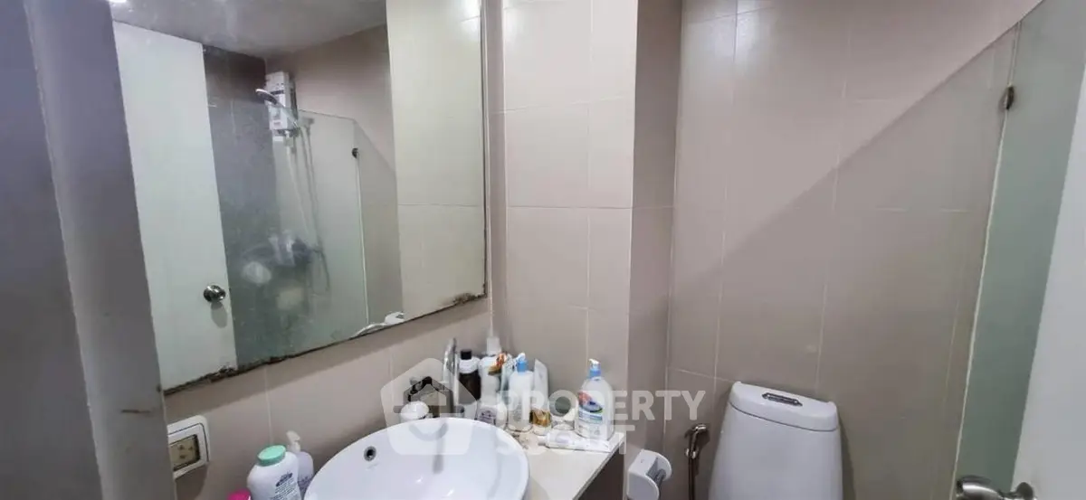 Compact bathroom with modern fixtures and ample storage space.