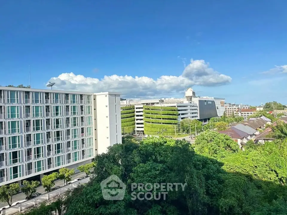 Stunning urban view with modern buildings and lush greenery under a clear blue sky.