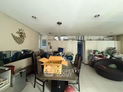 Spacious living room with dining area and modern decor, ideal for family gatherings.