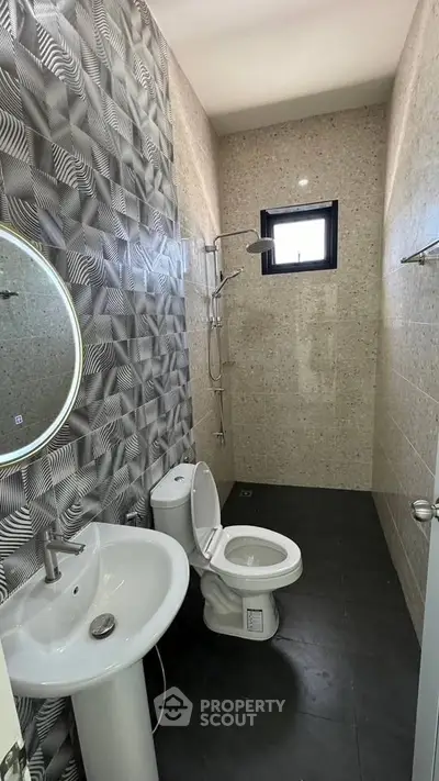 Modern bathroom with geometric tile design and sleek fixtures