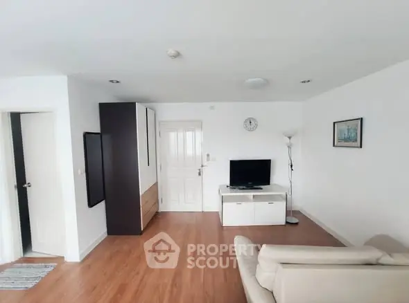 Spacious living room with modern decor and wooden flooring