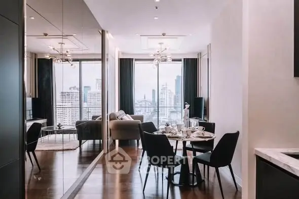 Modern living room with city view, elegant dining area, and stylish decor in a high-rise apartment.