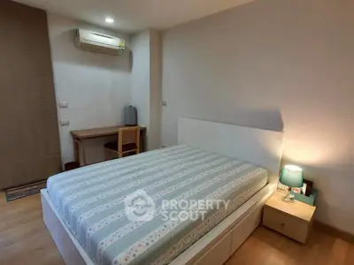 Cozy bedroom with modern furniture and ambient lighting in a stylish apartment.