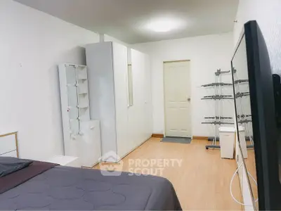 Spacious bedroom with modern furniture and ample storage space