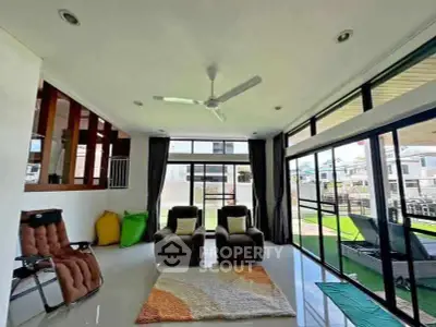 Spacious living room with modern design and large windows for natural light.