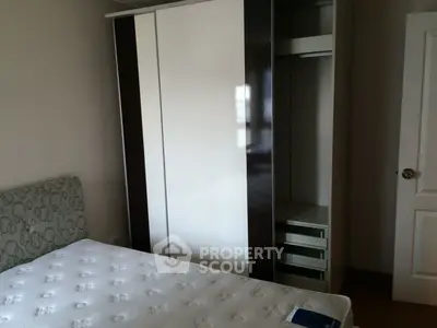 Cozy bedroom with modern wardrobe and comfortable mattress, perfect for restful nights.