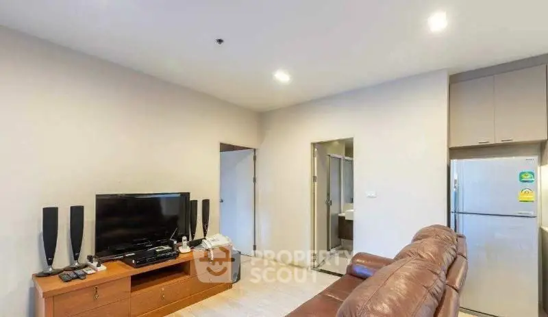Cozy living room with leather sofa and modern entertainment setup