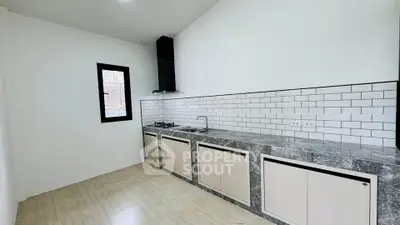 Modern kitchen with sleek countertops and gas stove in minimalist design