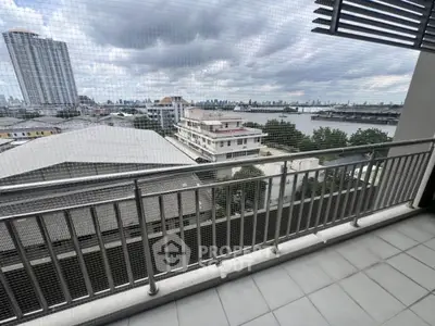 Spacious balcony with stunning city and river views, perfect for relaxation and enjoying the skyline.