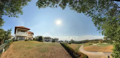Stunning panoramic view of luxury home with expansive garden and golf course