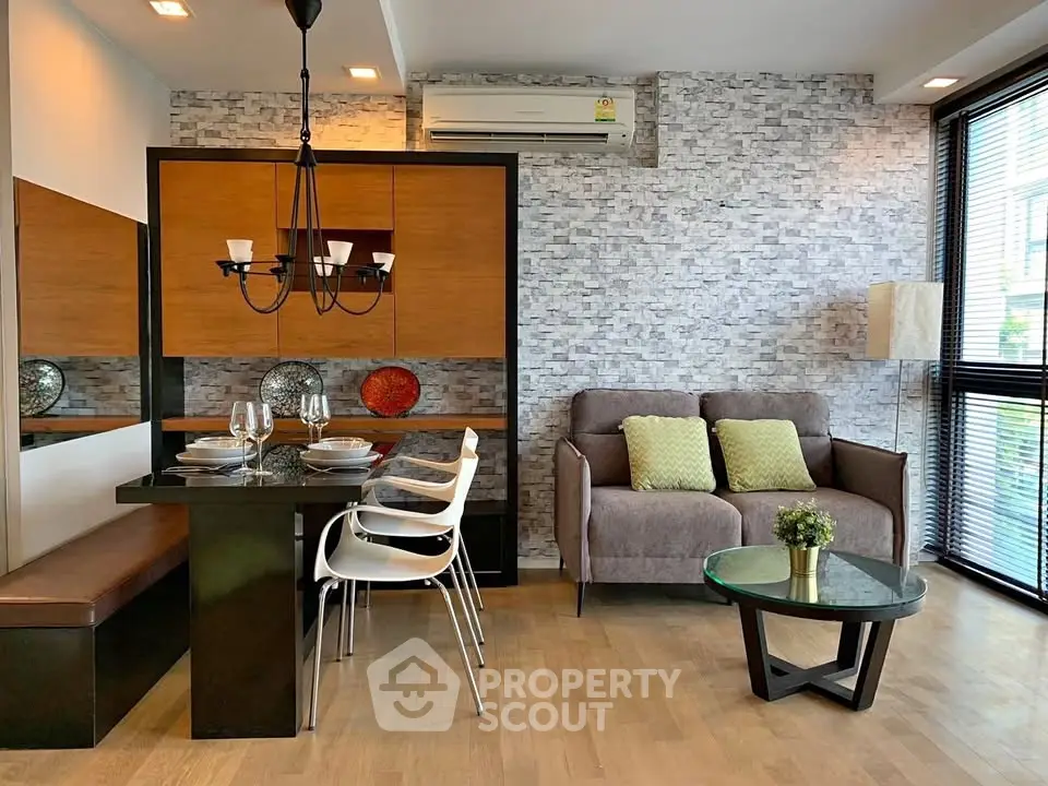 Modern living room with stylish dining area and cozy seating, featuring elegant decor and natural light.