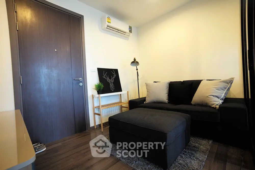 Cozy living room with modern decor and air conditioning in a stylish apartment.