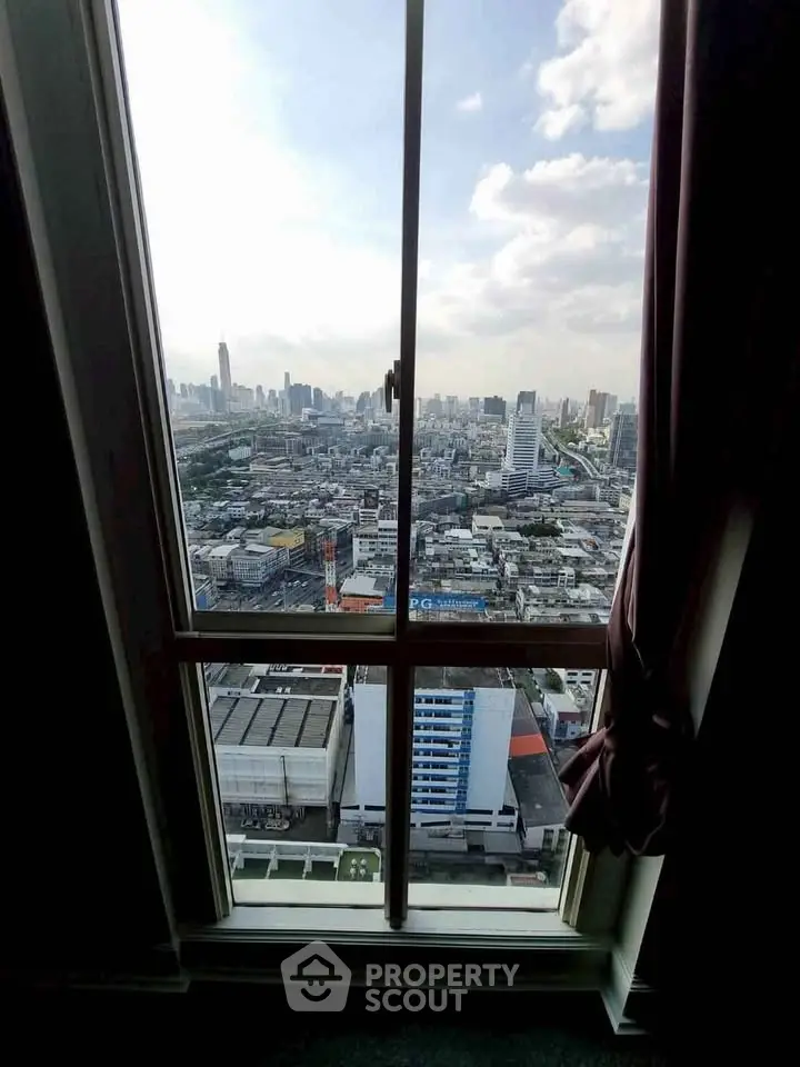 Stunning cityscape view from a high-rise window, showcasing urban skyline and vibrant city life.