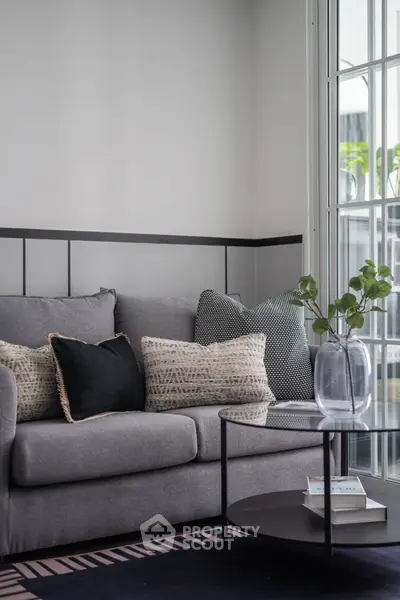 Stylish modern living room with cozy gray sofa and elegant decor