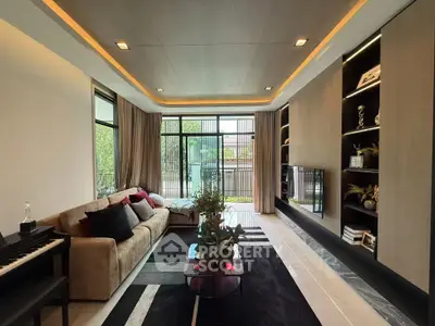 Luxurious modern living room with elegant decor and large windows offering natural light.