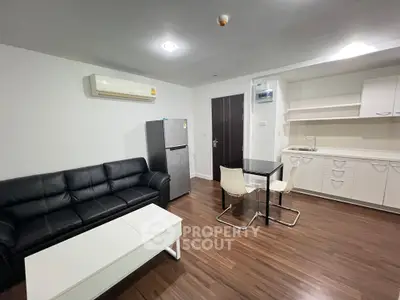 Modern living room with sleek furniture and compact kitchen area